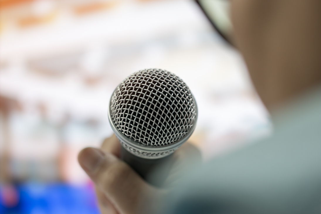 smart businesswoman speech and speaking with microphones in seminar room or talking conference hall light with microphones and keynote. Speech is vocalized form of communication humans
