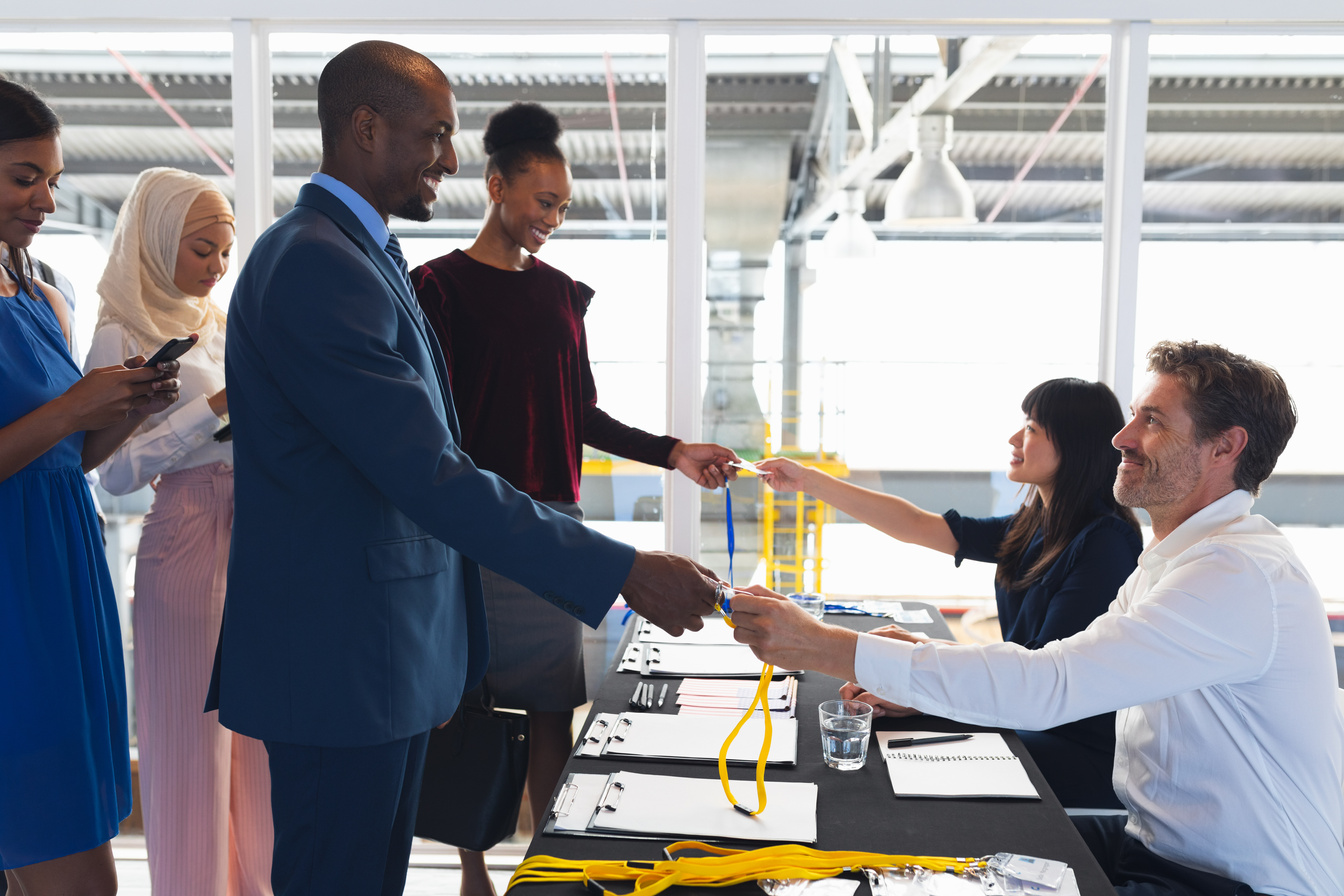 Business people checking in at conference registration table